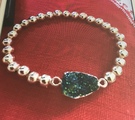 Rose Gold plated emerald coloured resin stone bracelet - Image 1